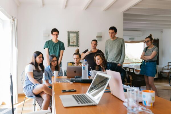 group of people watching on laptop